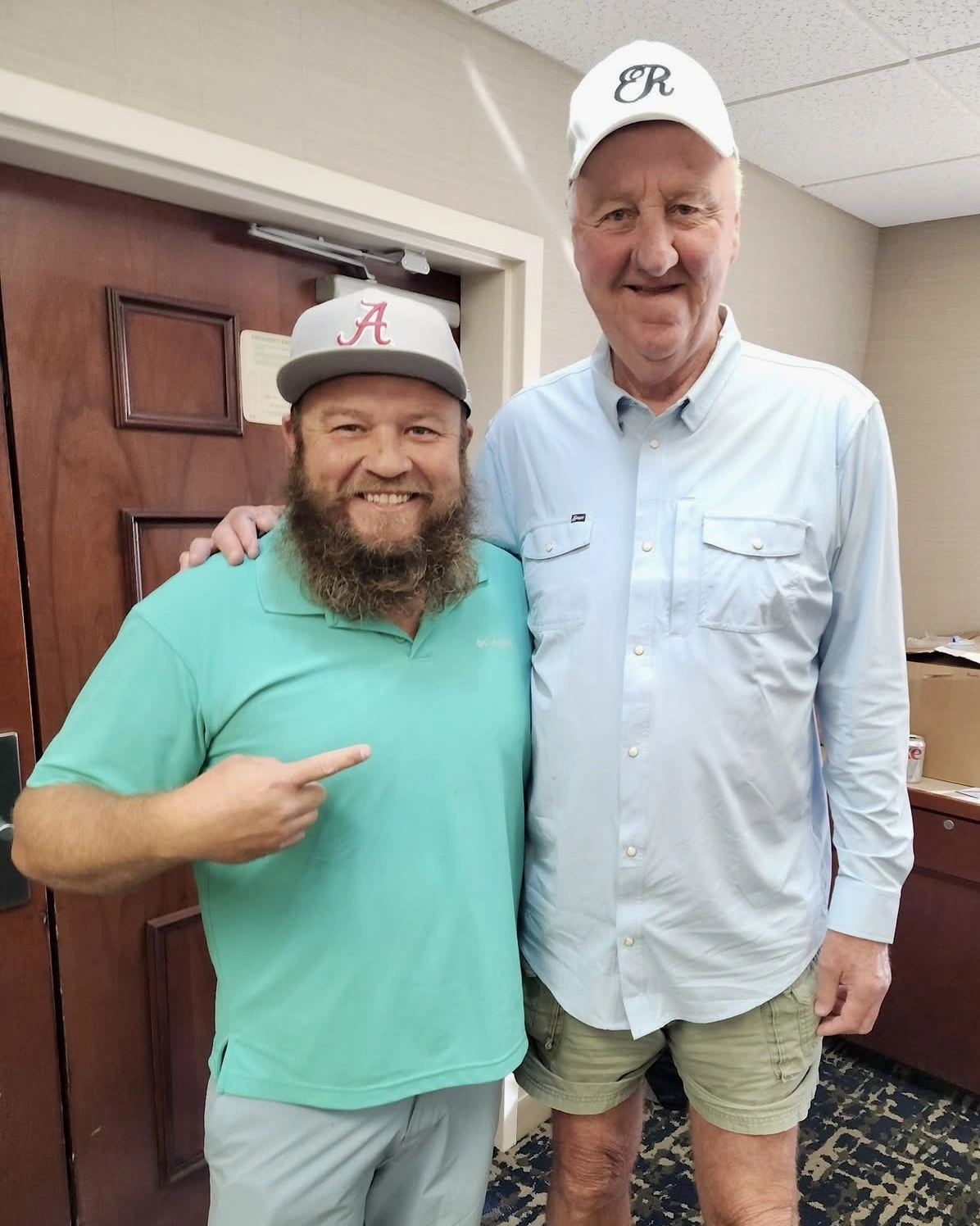 Larry Bird with a representative of Vault Autographs at the private signing.