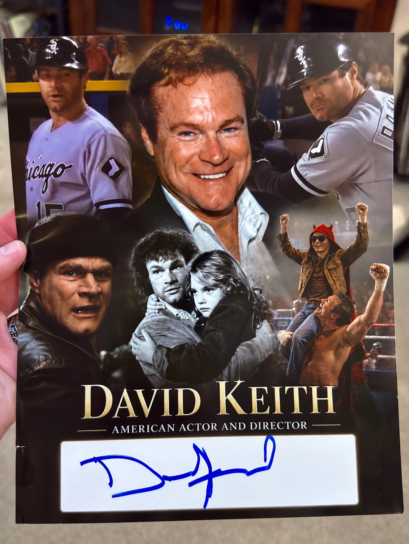 Scott Brooks holding his custom David Keith career collage with Keith’s blue autograph across the white signing area.