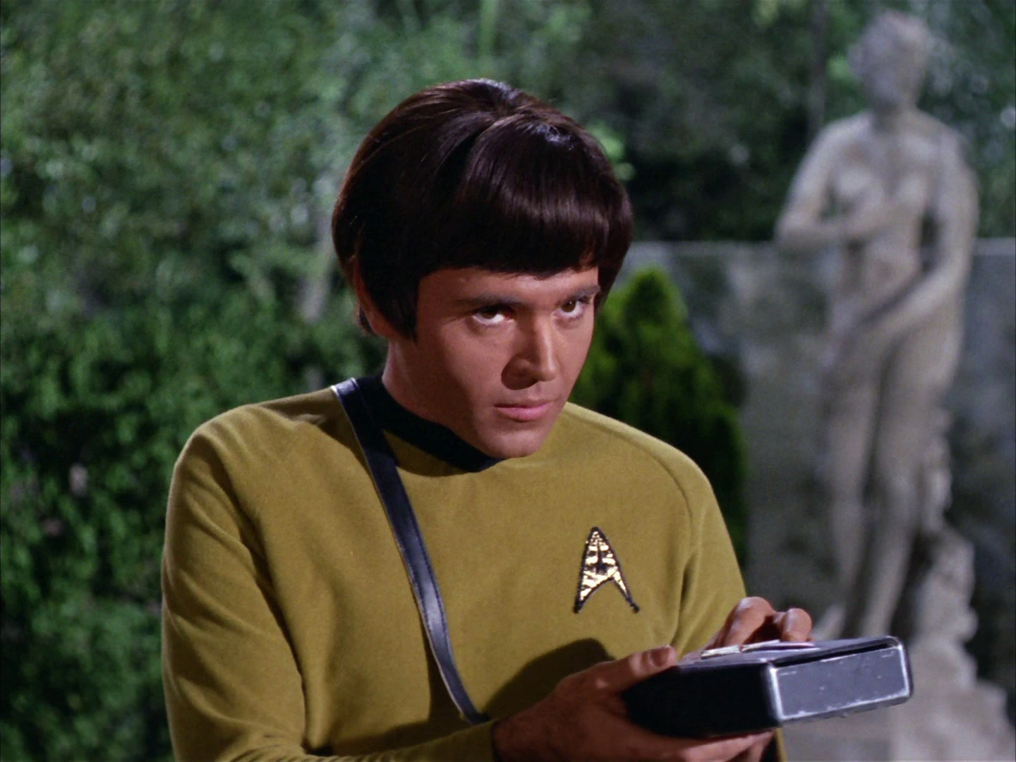 Walter Koenig as Chekov holding a tricorder during a landing-party mission in Who Mourns for Adonais?