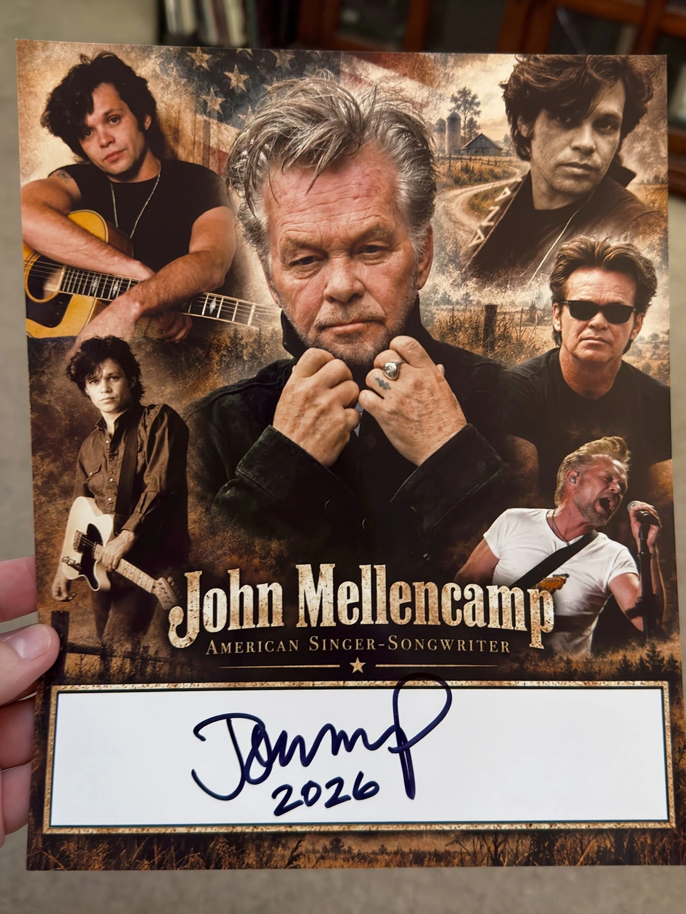 Scott Brooks holding his custom John Mellencamp career collage, signed in dark ink across the white autograph box and dated 2026.